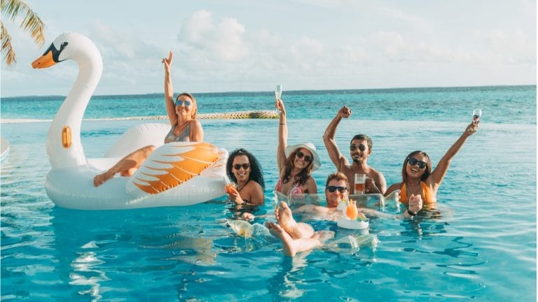 Group of young people having fun in the Solis Pool at Nova Maldives