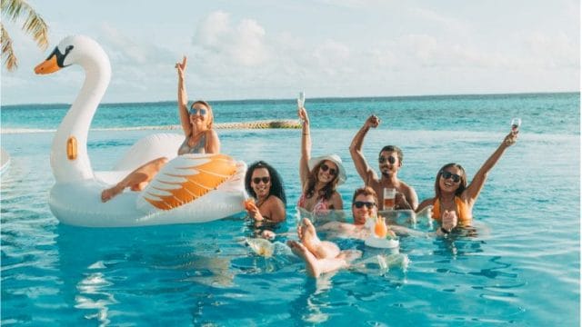 Group of young people having fun in the Solis Pool at Nova Maldives