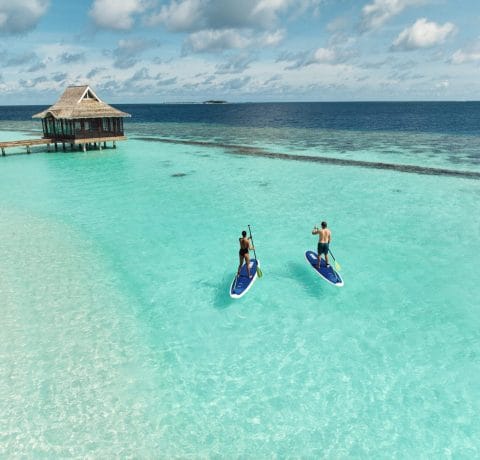 Stand up paddle boarding at Nova Maldives' lagoon