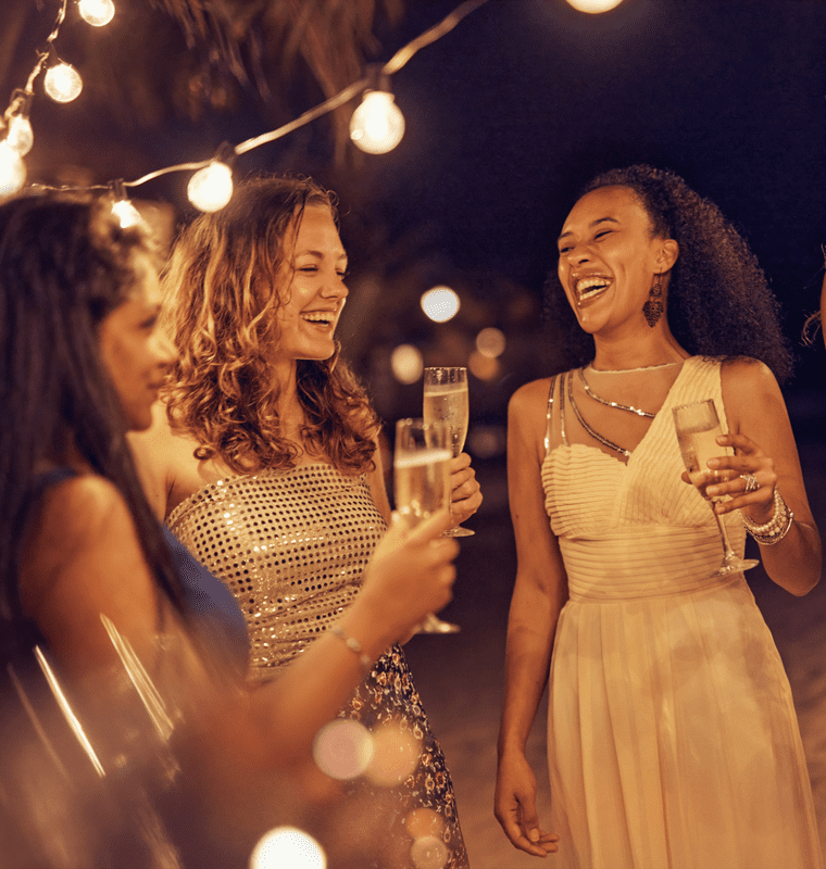 a group of women holding drinks having fun