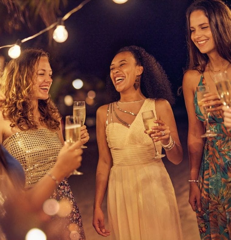 A group of women with champagne flutes, laughing together
