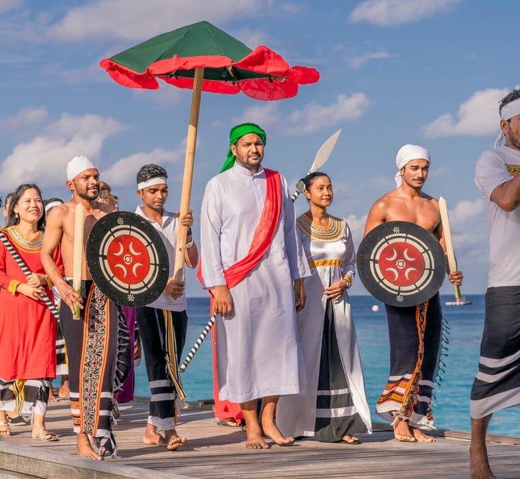 Cultural procession featuring dancers and drummers at a traditional Maldivian event.