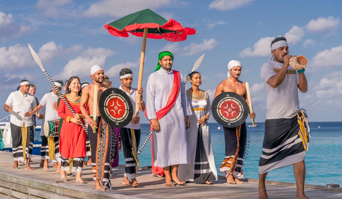 Cultural procession featuring dancers and drummers at a traditional Maldivian event.