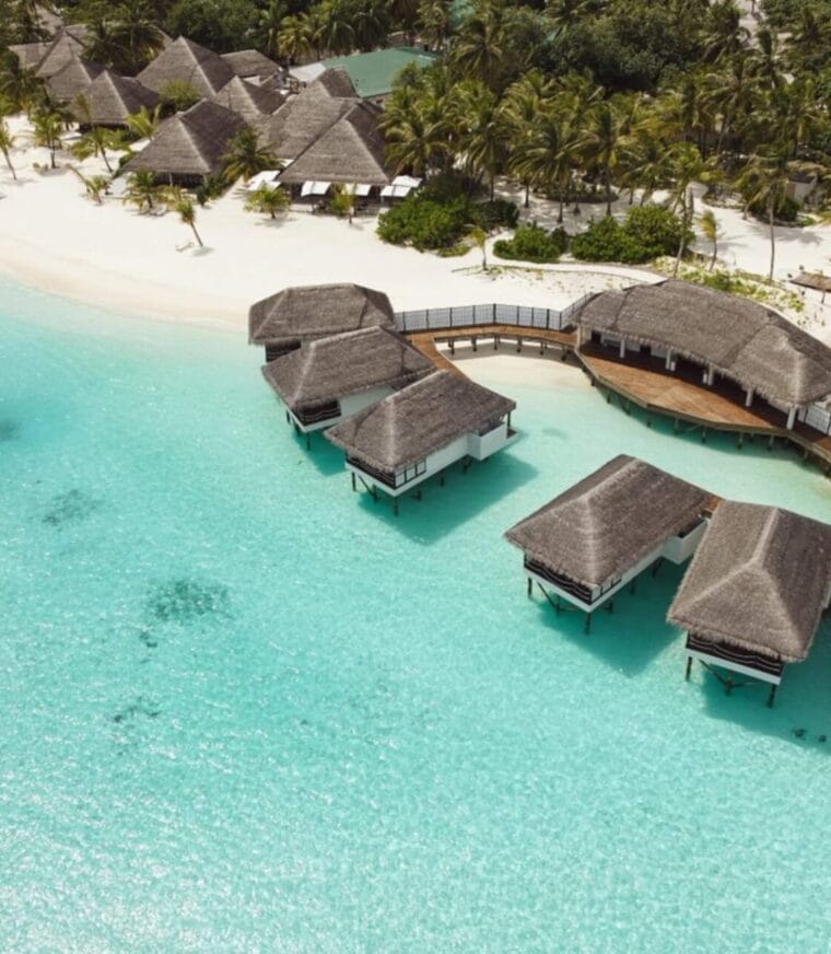 Aerial view of overwater spa on the turquoise Maldivian ocean.