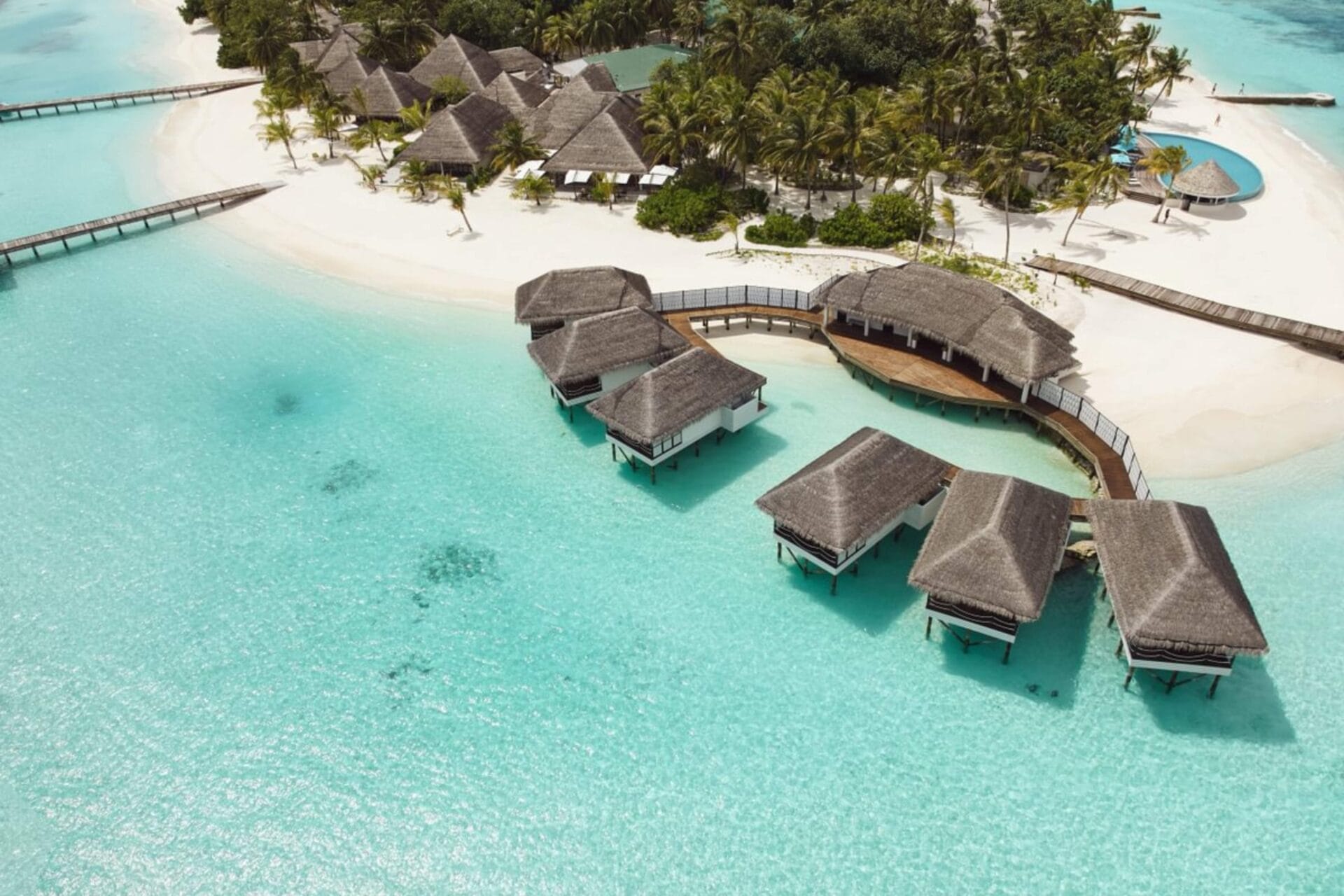 Aerial view of overwater spa on the turquoise Maldivian ocean.